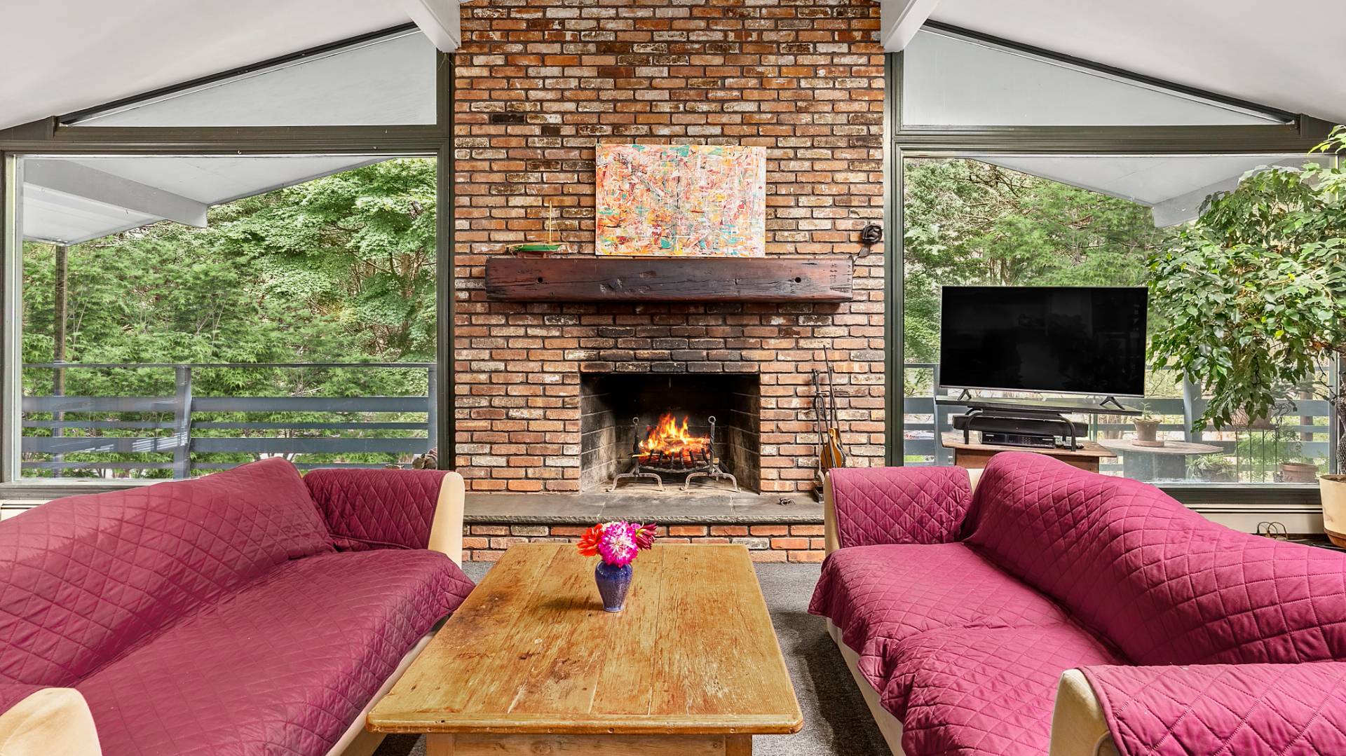 11 Shoridge East Hampton, NY 11937 - Photo 5 of 14 a living room with furniture a flat screen tv and a fireplace