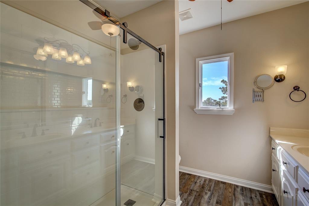 7359 Highway 154 Sulphur Springs, TX 75482 - Photo 27 of 40 upstairs primary bath has oversized walk in shower with glass doors, double vanity