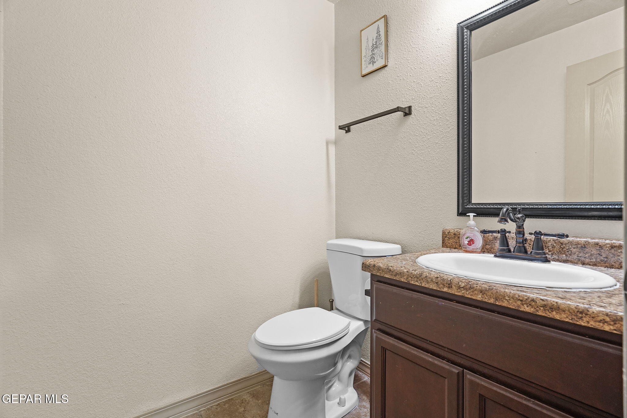 3152 Rustic Hidden Drive El Paso, TX 79938 - Photo 28 of 38 a bathroom with a granite countertop toilet and a sink