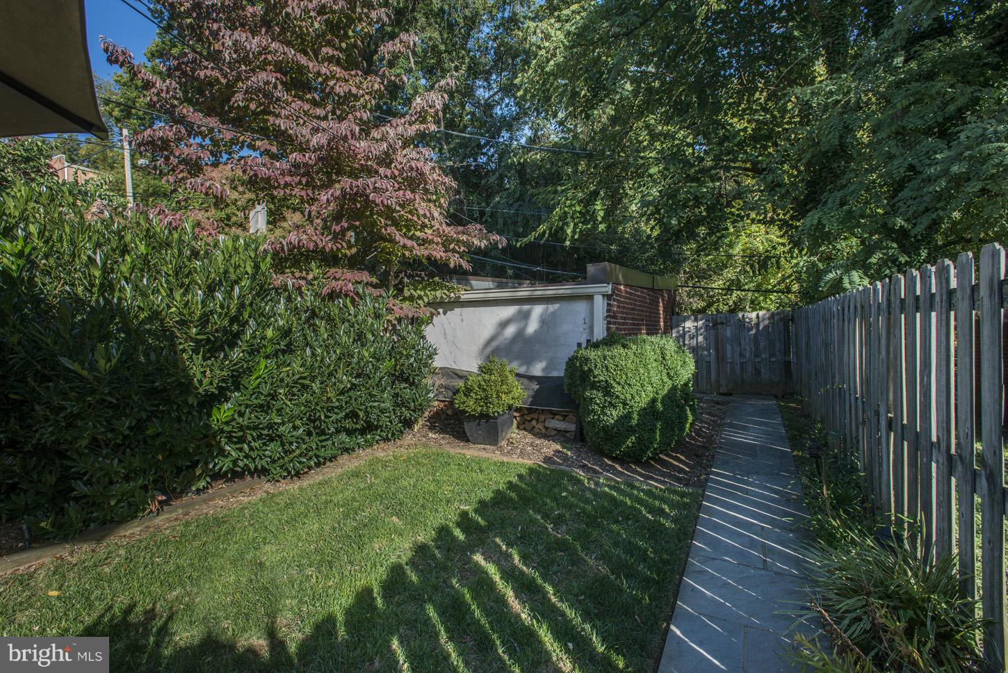 3813 T Street Northwest Washington, DC 20007 - Photo 21 of 24 a view of garden with wooden bench in a yard