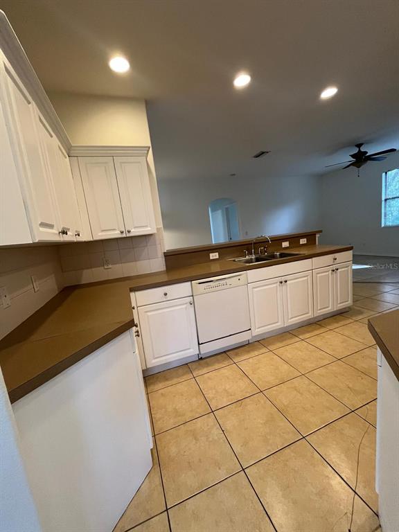 4458 Maverick Street North Port, FL 34288 - Photo 3 of 8 a kitchen with granite countertop white cabinets and white appliances