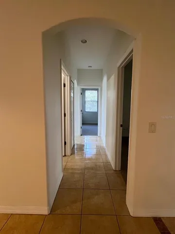 a hallway with sliding door and yard in back