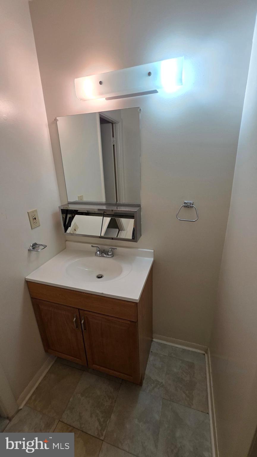 3928 Rolling Rd., Unit C10 Pikesville, MD 21208 - Photo 15 of 26 a bathroom with a sink and a mirror