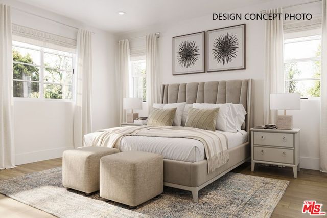 a bed room with a bed and a painting on the wall