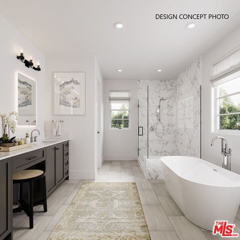 a spacious bathroom with a tub sink shower and mirror