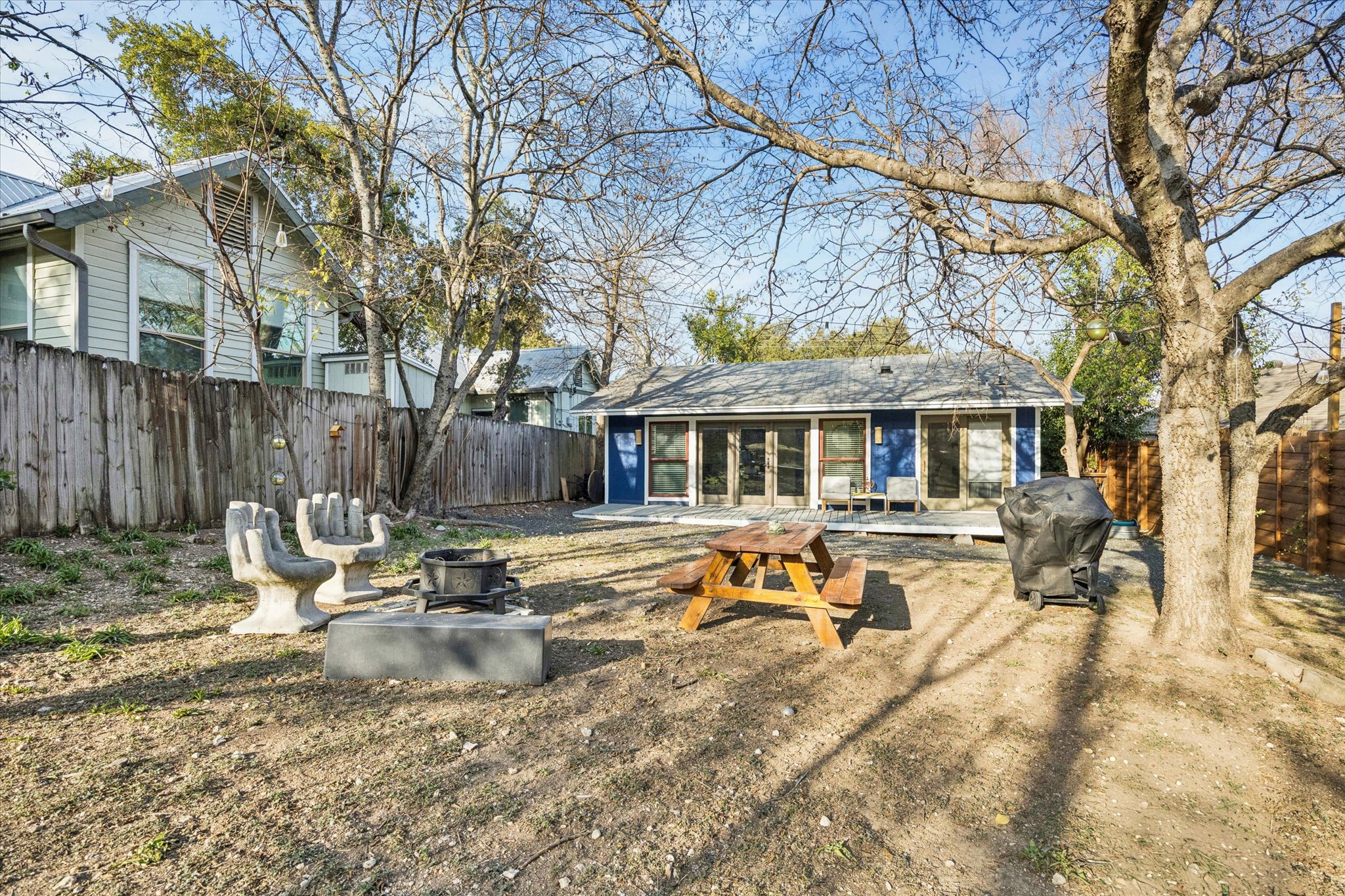 213 Lessin Lane Austin, TX 78704 - Photo 16 of 16 Back of property with a fenced backyard, a patio, and a sunroom
