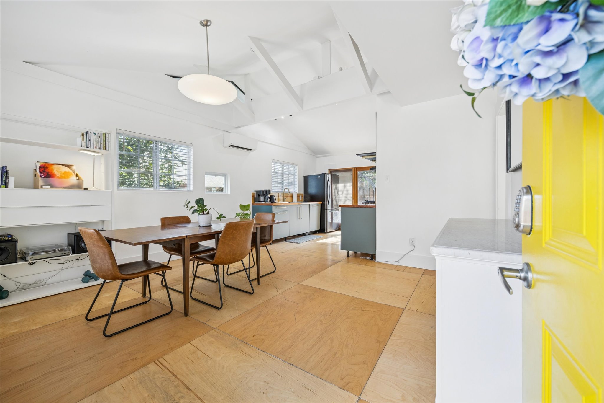 213 Lessin Lane Austin, TX 78704 - Photo 3 of 16 Dining space featuring a high ceiling and a wall mounted AC