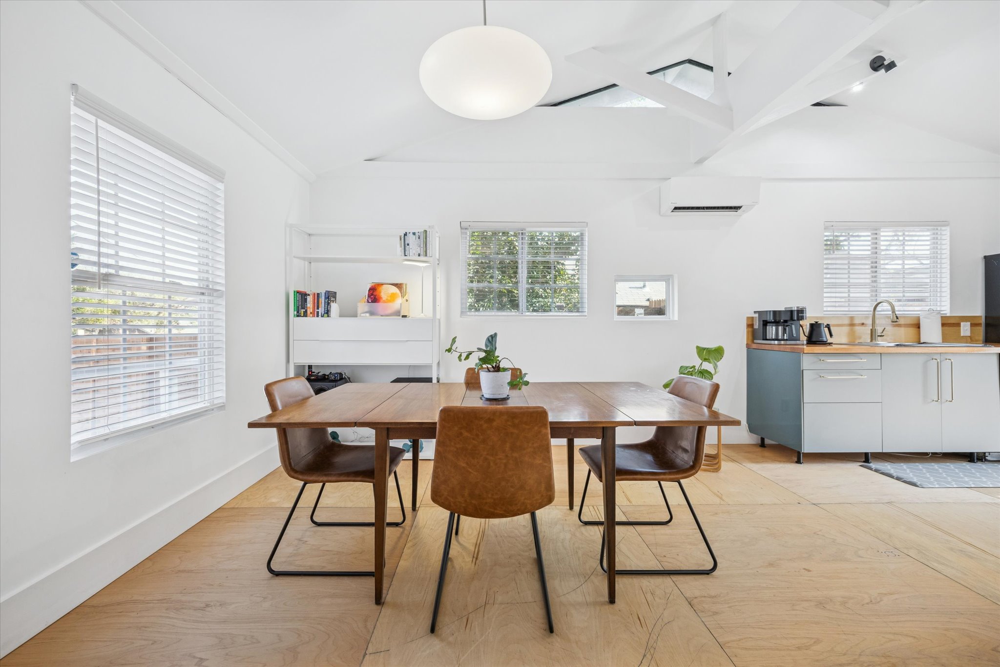 213 Lessin Lane Austin, TX 78704 - Photo 6 of 16 Dining room with vaulted ceiling, light wood-style floors, and a wall mounted mini split