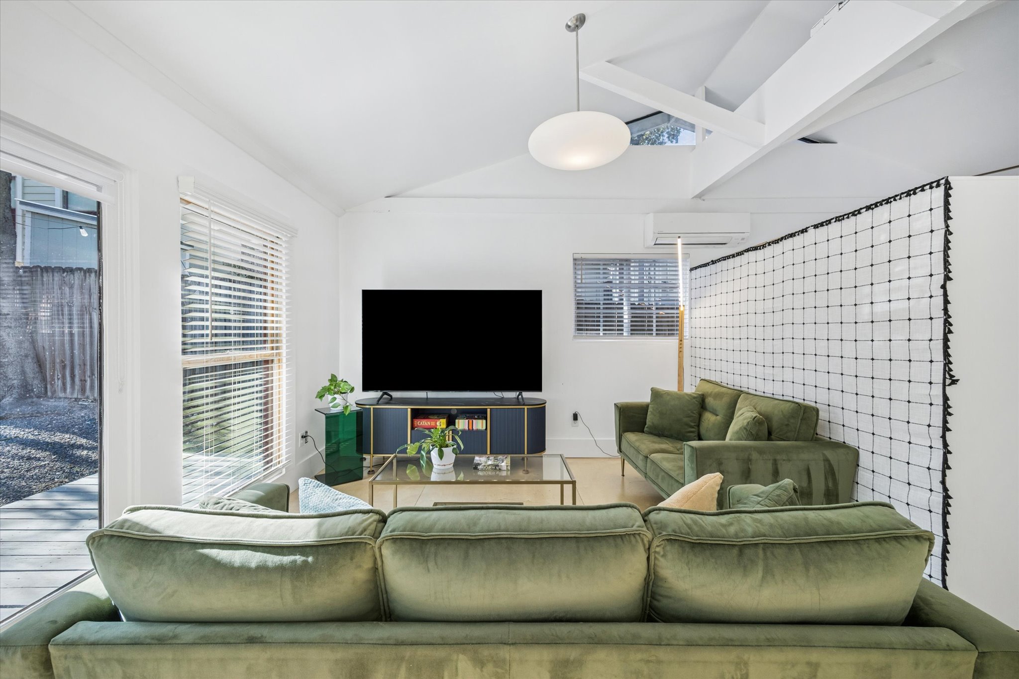213 Lessin Lane Austin, TX 78704 - Photo 9 of 16 Living area with lofted ceiling and a wall mounted mini split