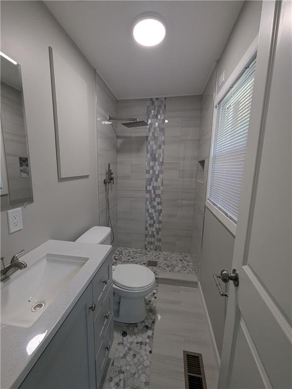 4308 Sheppard Drive Conley, GA 30288 - Photo 11 of 11 a bathroom with a sink a toilet and shower