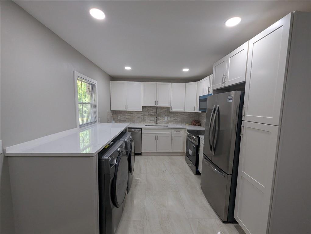 4308 Sheppard Drive Conley, GA 30288 - Photo 4 of 11 a kitchen with stainless steel appliances granite countertop refrigerator sink and cabinets