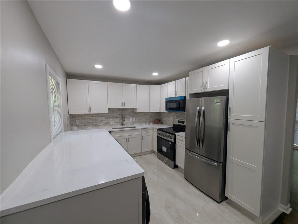 4308 Sheppard Drive Conley, GA 30288 - Photo 5 of 11 a kitchen with a refrigerator a sink and a microwave