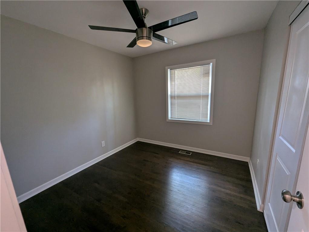 4308 Sheppard Drive Conley, GA 30288 - Photo 7 of 11 an empty room with wooden floor fan and windows