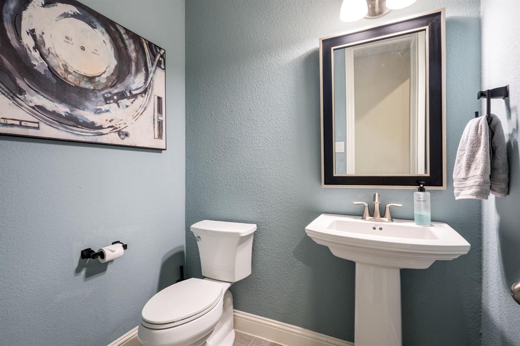 1501 Snowdrop Drive Prosper, TX 75078 - Photo 25 of 27 a bathroom with a toilet sink and mirror