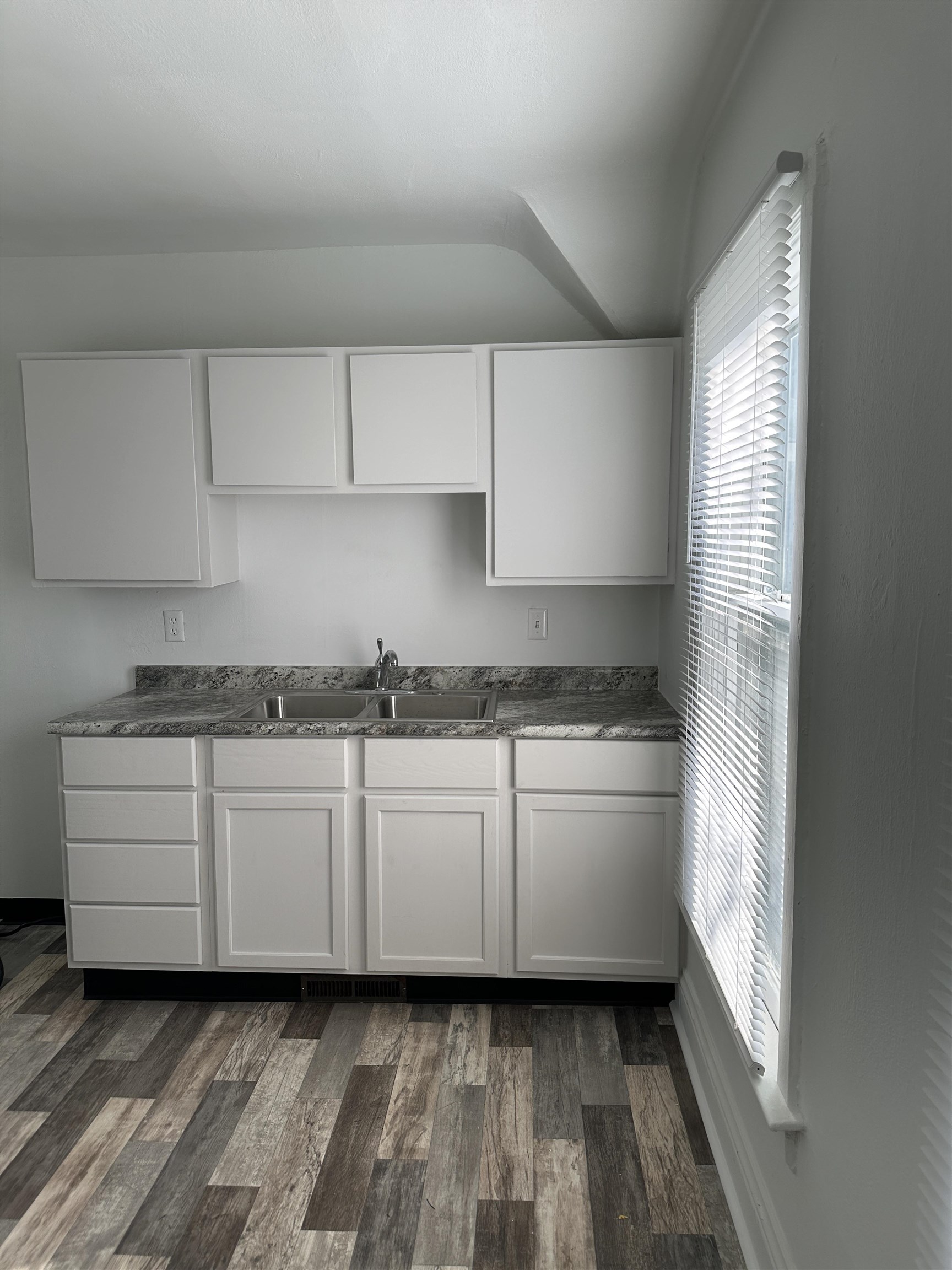 309 West Pleasant Street Freeport, IL 61032 - Photo 26 of 33 a kitchen with granite countertop white cabinets and white appliances