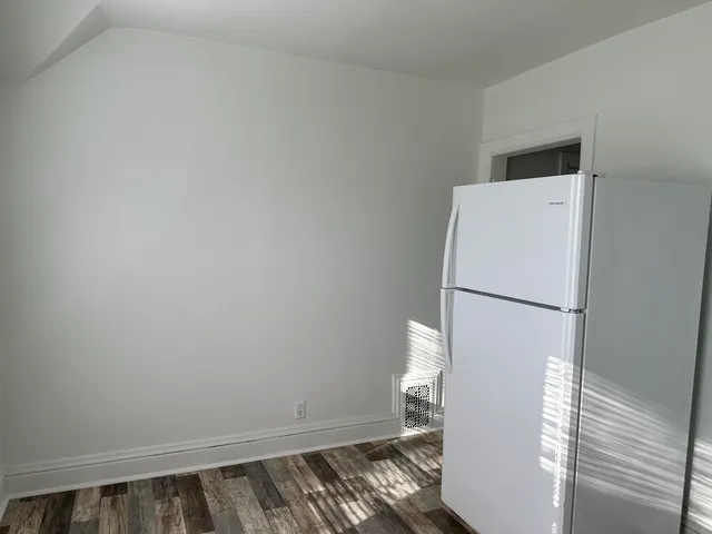 a view of a kitchen with a refrigerator and microwave