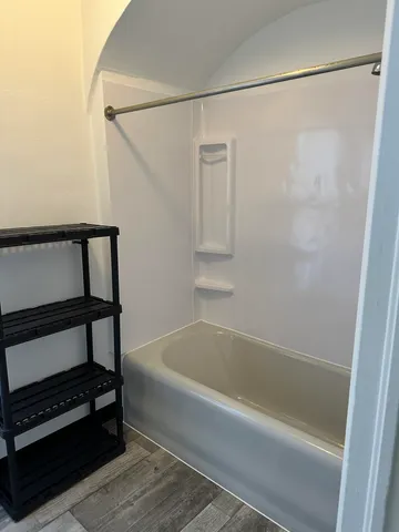 a bathroom with a bathtub and a shower