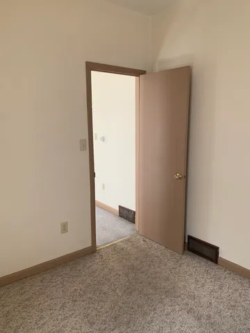 an empty room with closet area
