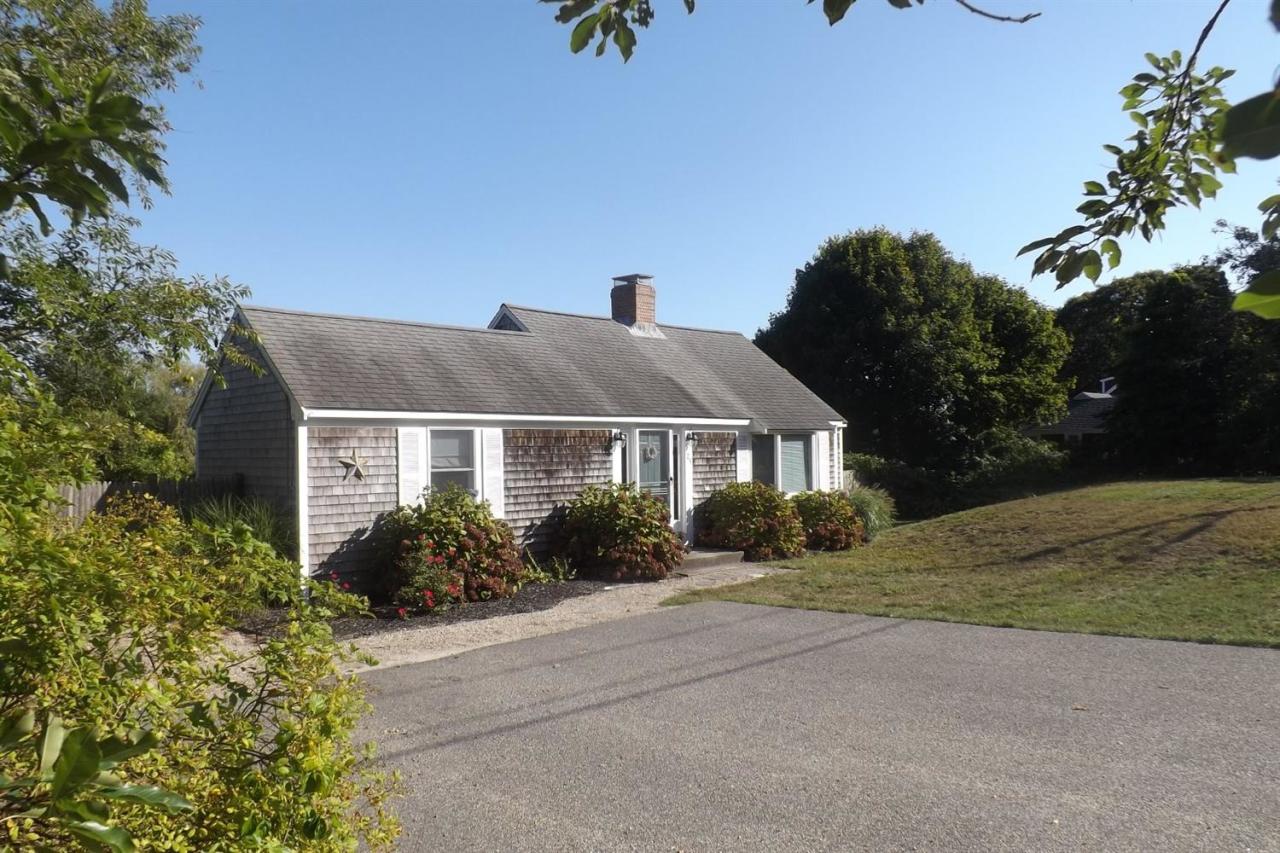 25 Doane Road Harwich Port, MA 02646 - Photo 2 of 18 front view of house with a yard
