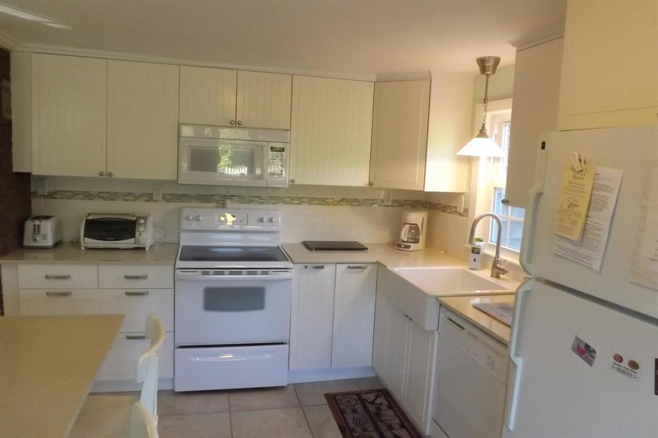 25 Doane Road Harwich Port, MA 02646 - Photo 3 of 18 a kitchen with stainless steel appliances granite countertop a sink stove and cabinets