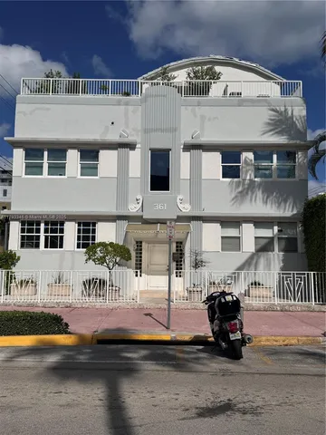 a view of building with glass windows and a table