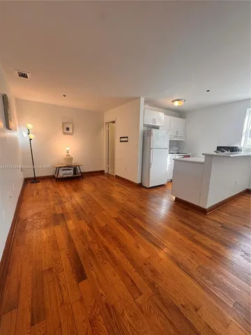 a view of a kitchen with wooden floor