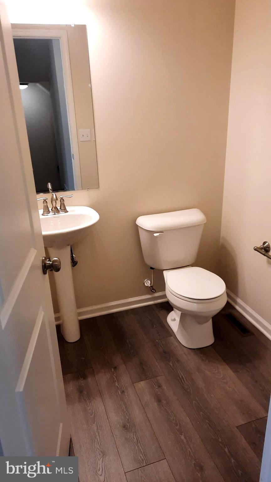 945 Admiral's Quay Drive Mechanicsburg, PA 17050 - Photo 8 of 15 a bathroom with a toilet sink and mirror