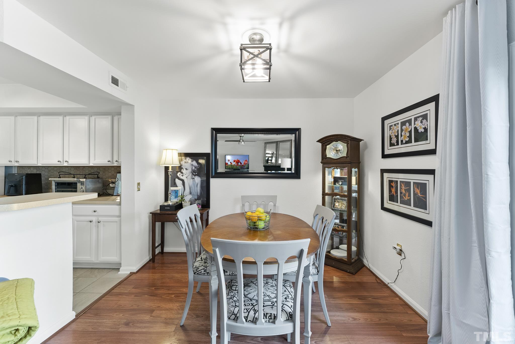 2408 Condor Court, Unit UN2408 Raleigh, NC 27615 - Photo 14 of 39 a view of a dining room with furniture and wooden floor