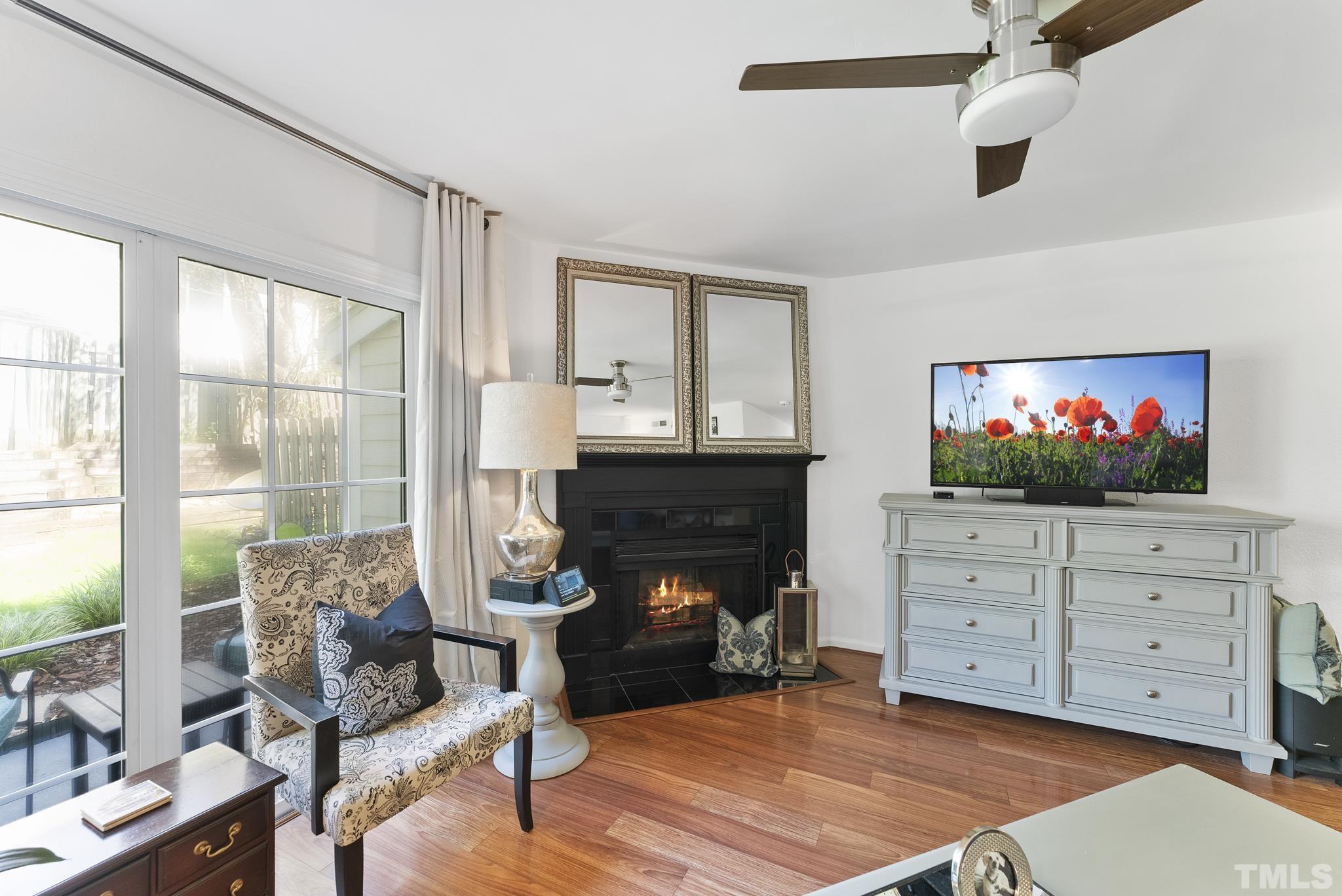 2408 Condor Court, Unit UN2408 Raleigh, NC 27615 - Photo 17 of 39 a living room with furniture a fireplace and a flat screen tv