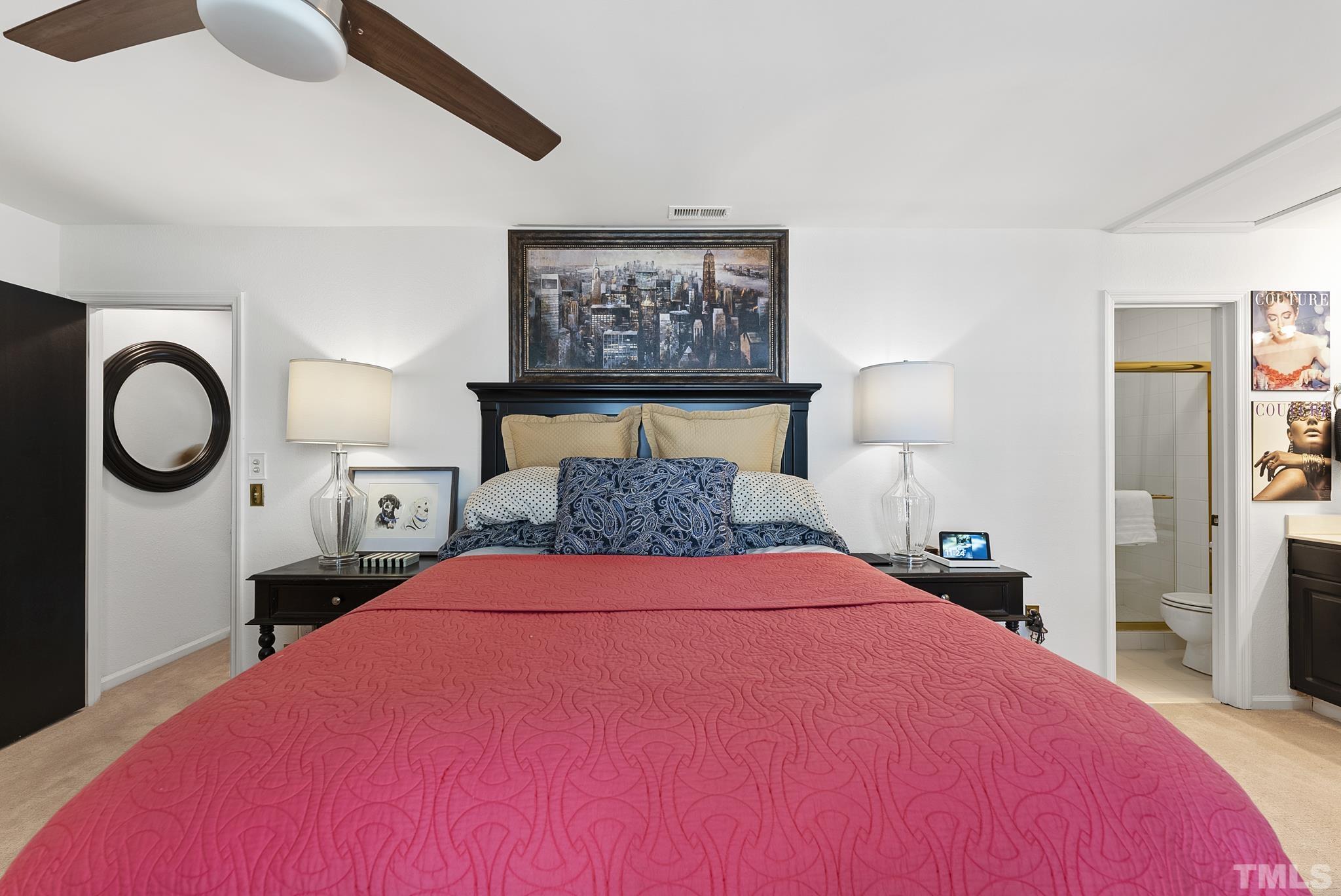 2408 Condor Court, Unit UN2408 Raleigh, NC 27615 - Photo 23 of 39 a bedroom with a bed and a chandelier