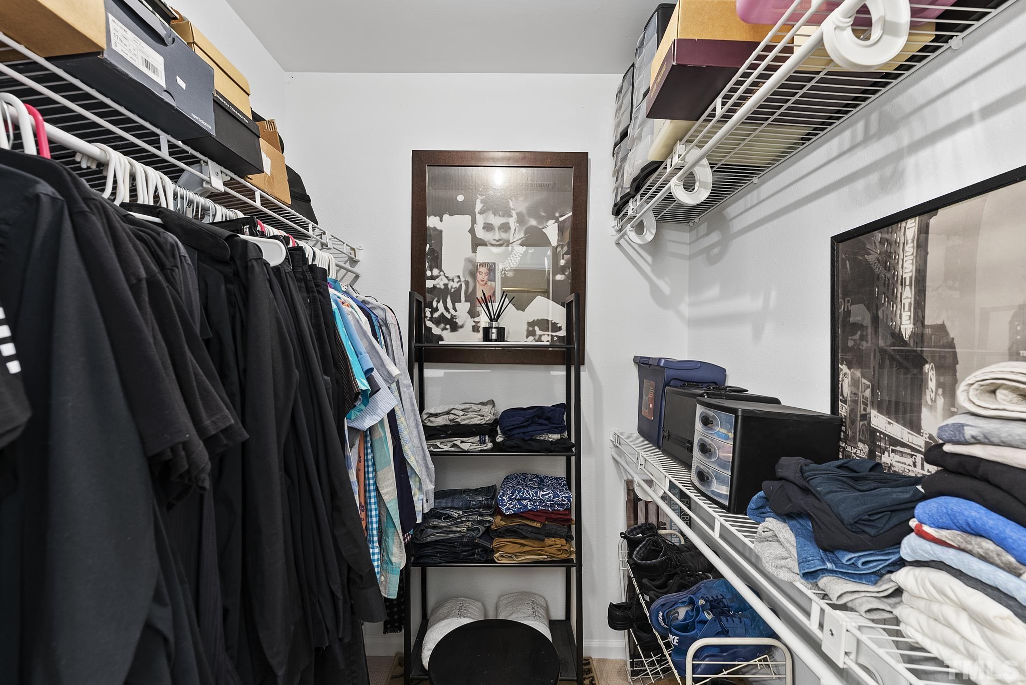 2408 Condor Court, Unit UN2408 Raleigh, NC 27615 - Photo 26 of 39 a view of walk in closet with clothes and shoes