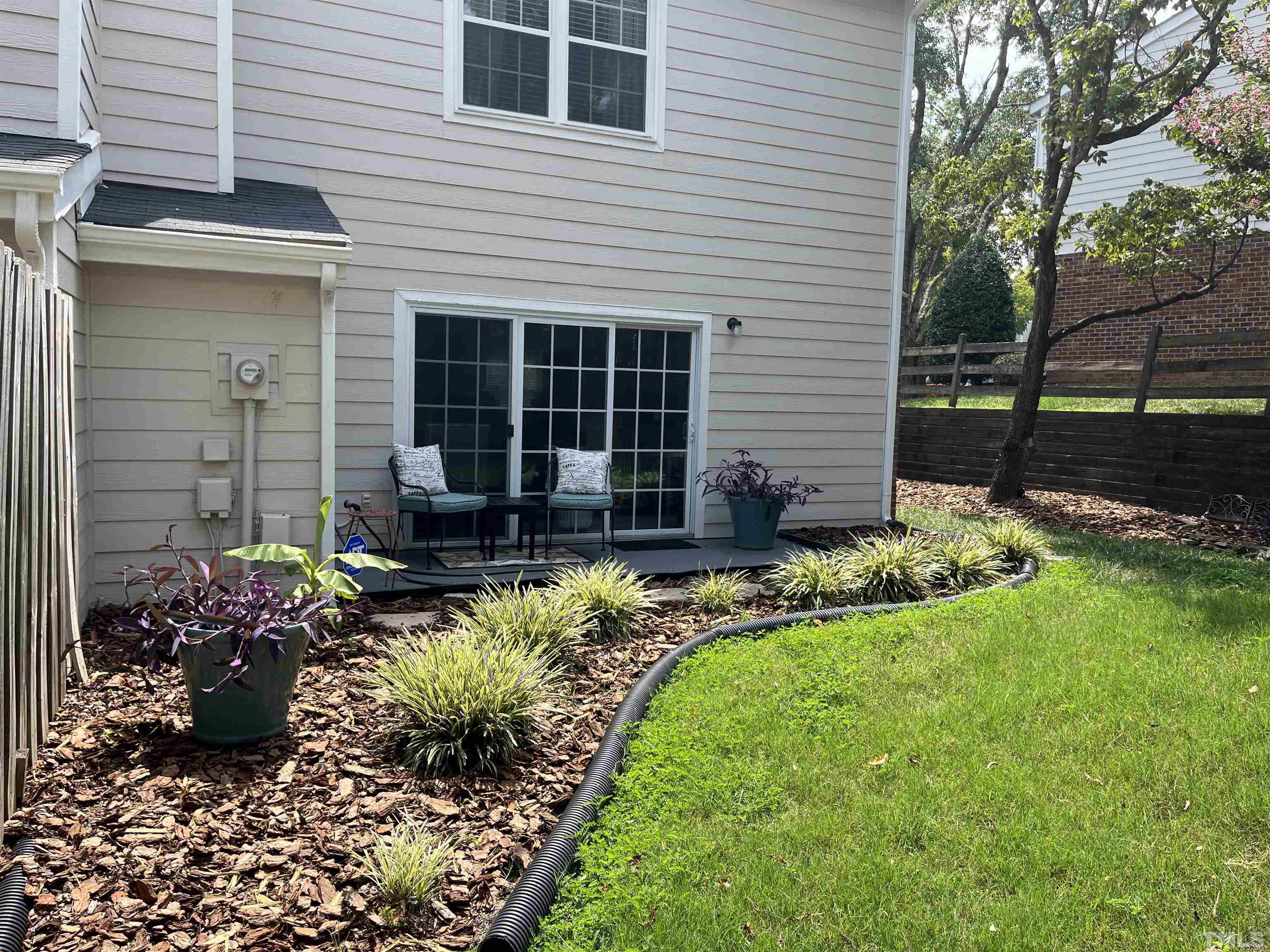 2408 Condor Court, Unit UN2408 Raleigh, NC 27615 - Photo 34 of 39 a front view of a house with a yard and a garden