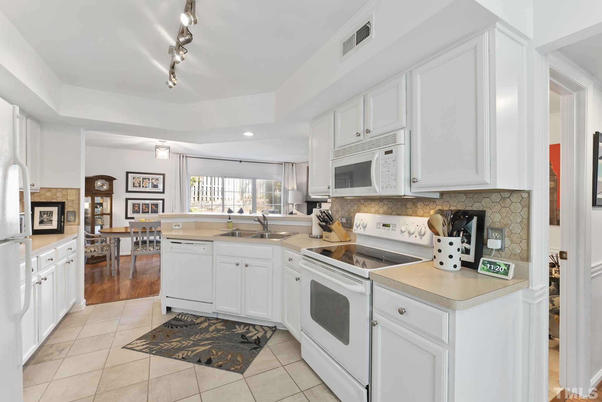 2408 Condor Court, Unit UN2408 Raleigh, NC 27615 - Photo 7 of 39 a kitchen with a sink window and cabinets