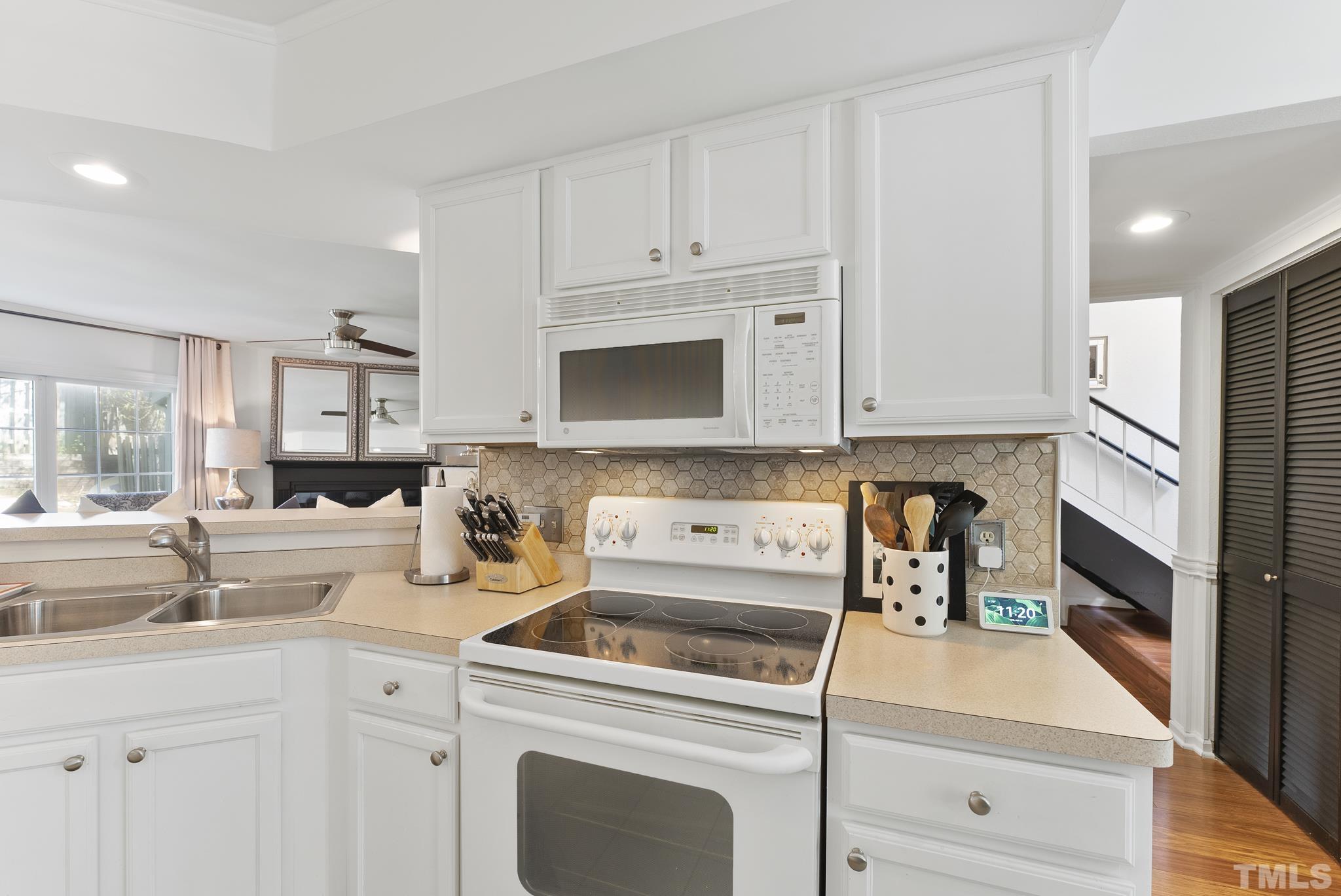2408 Condor Court, Unit UN2408 Raleigh, NC 27615 - Photo 9 of 39 a kitchen with white cabinets and white appliances
