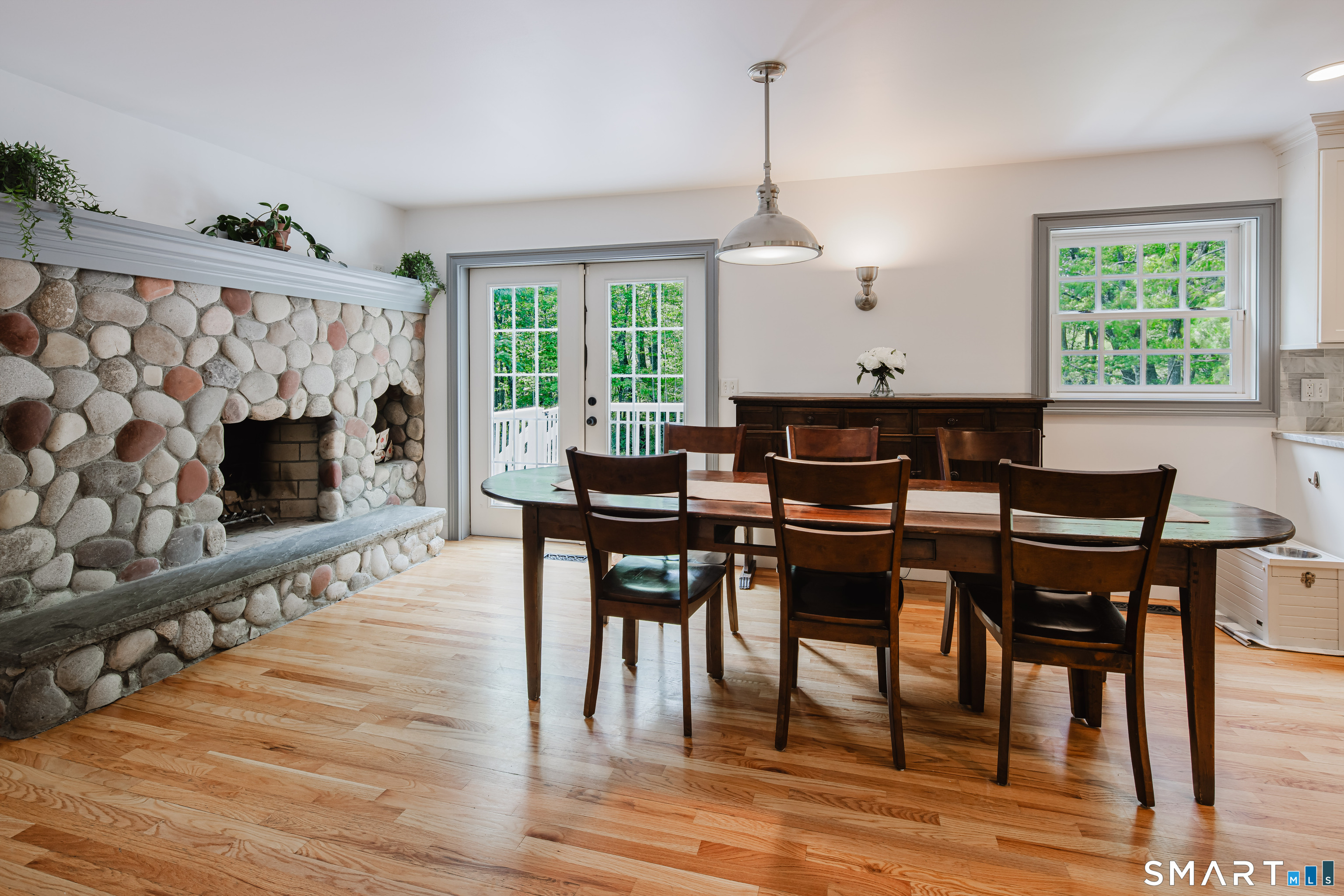 3 Partridge Trail Sherman, CT 06784 - Photo 14 of 37 a dining room with wooden floor a chandelier a wooden table and chairs