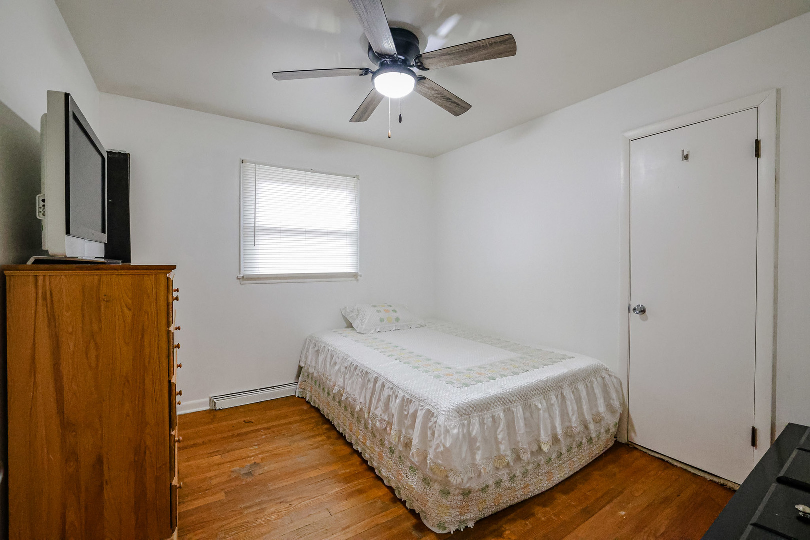 14622 Wabash Avenue Dolton, IL 60419 - Photo 6 of 18 a bedroom with a bed and wooden floor