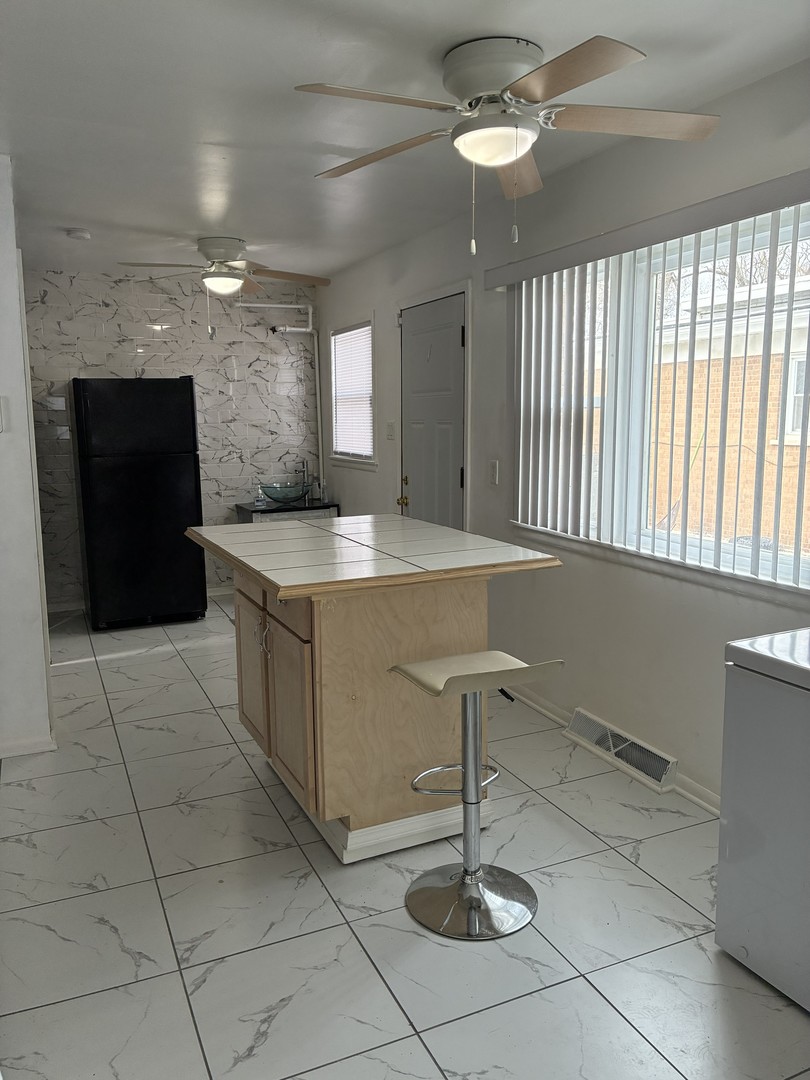 14622 Wabash Avenue Dolton, IL 60419 - Photo 9 of 18 a kitchen with a sink appliances and cabinets