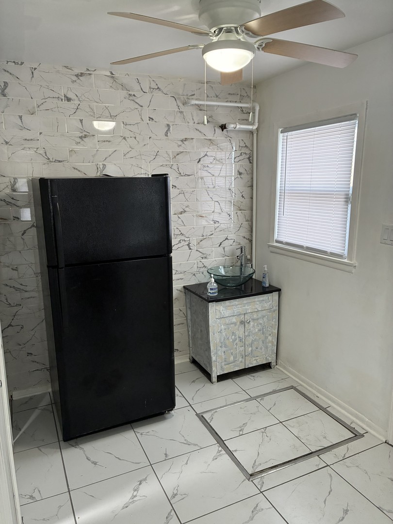 14622 Wabash Avenue Dolton, IL 60419 - Photo 10 of 18 a room with a table and a fireplace