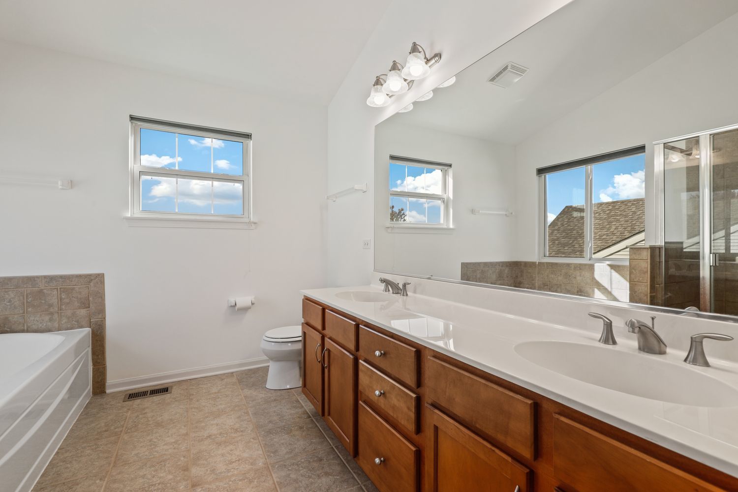 3501 Mustang Road Joliet, IL 60435 - Photo 15 of 35 a bathroom with a double vanity sink and a mirror