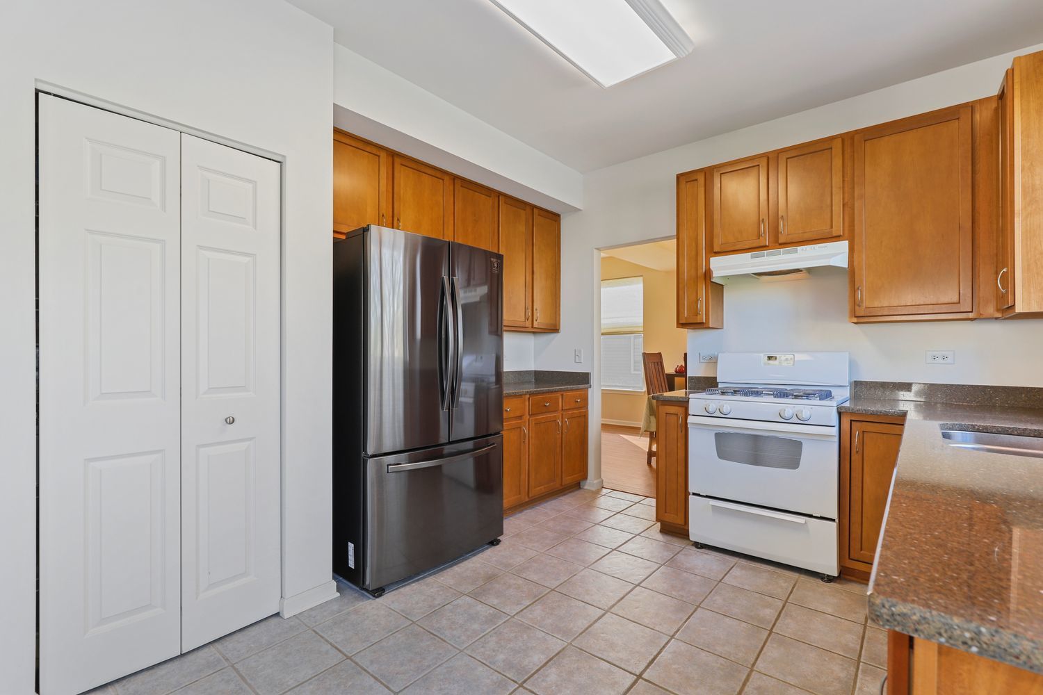 3501 Mustang Road Joliet, IL 60435 - Photo 5 of 35 a kitchen with stainless steel appliances granite countertop a refrigerator and a stove top oven