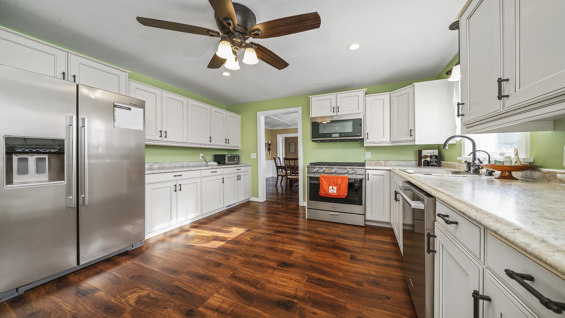 211 North Shabbona Road Shabbona, IL 60550 - Photo 6 of 33 a kitchen with stainless steel appliances granite countertop a refrigerator a stove top oven a sink and dishwasher with wooden floor