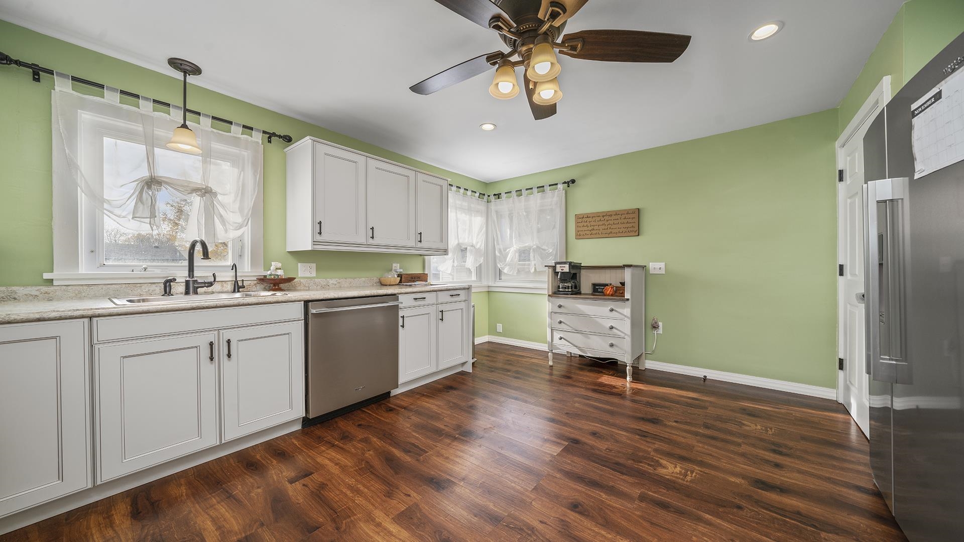 211 North Shabbona Road Shabbona, IL 60550 - Photo 8 of 33 a kitchen with a refrigerator and white cabinets