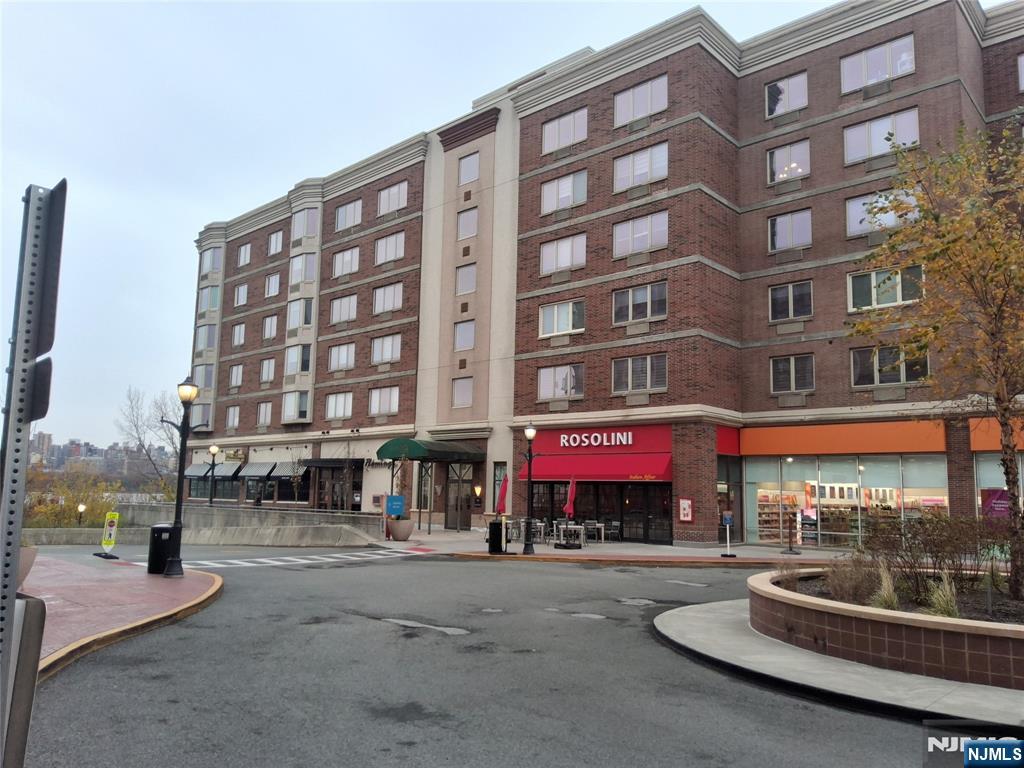 a building with glass windows and a street