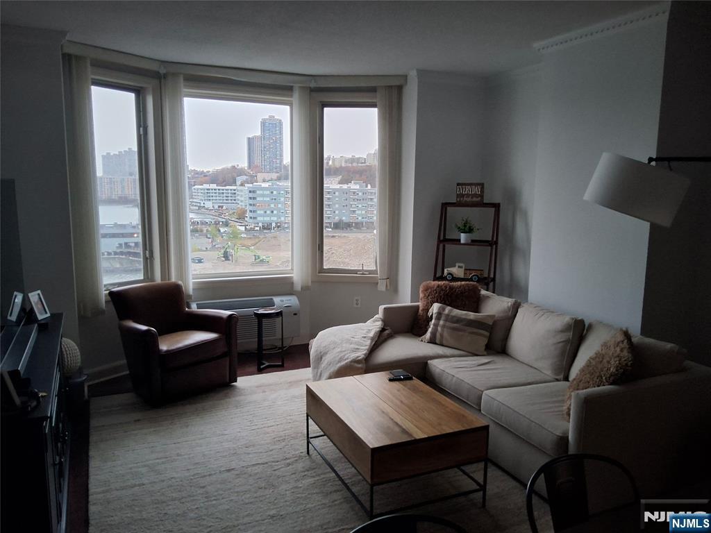 6407 City Place, Unit 6407 Edgewater, NJ 07020 - Photo 8 of 9 a living room with furniture and a window