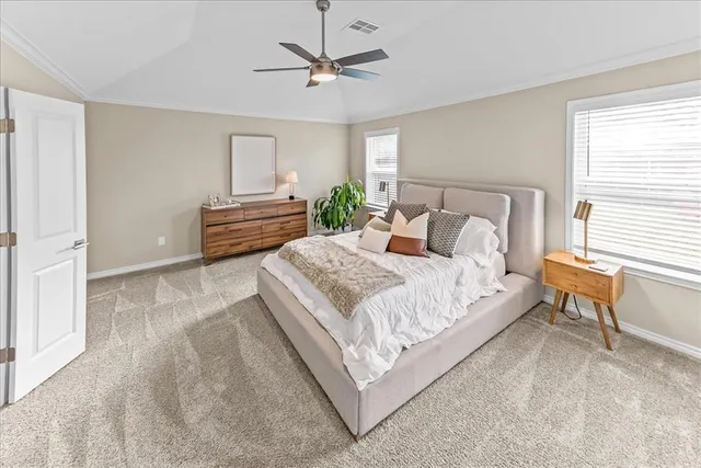 a bedroom with a bed and a chandelier