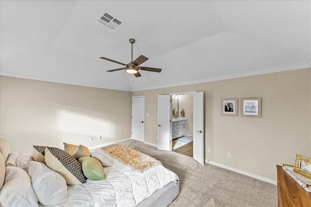 a bedroom with a bed and ceiling fan