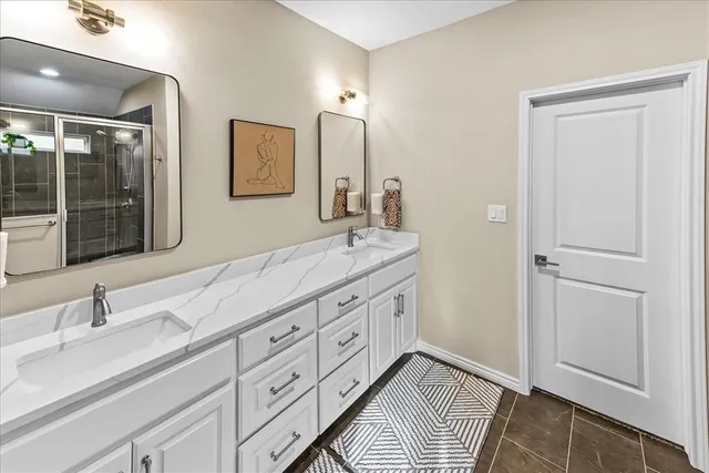 a bathroom with a glass door shower