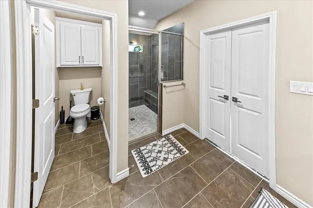 a view of walk in closet with clothes and shoes