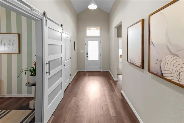 a living room with furniture a fireplace and a chandelier