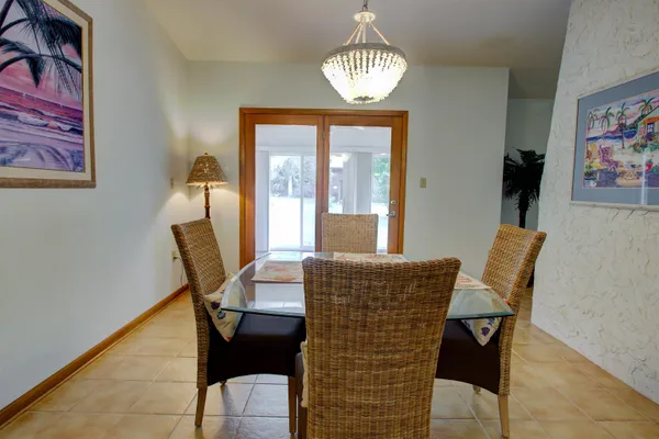 a view of a dining room with furniture and chandelier
